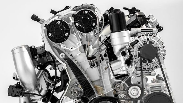 A close-up studio image of a car engine with a detailed cutaway view