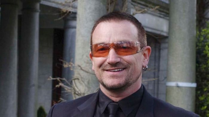 In 2007, Bono was photographed after receiving a knighthood to honor his significant contributions to both the music industry and his humanitarian efforts.