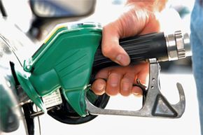 individual refueling a gas tank