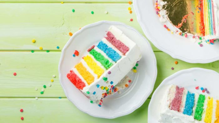 Slices of a rainbow layer cake.