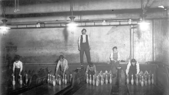 Child pinsetters at work in a Brooklyn, New York bowling alley in 1910.