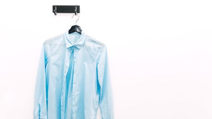 Wrinkled shirt hanging up.