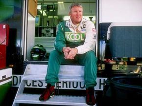 Paul Tracy relaxing on the steps of a race car trailer