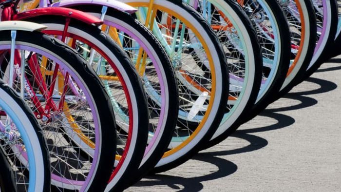 A collection of brightly colored bicycle wheels.