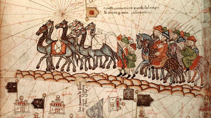 Marco Polo traveling with a caravan toward Asia.