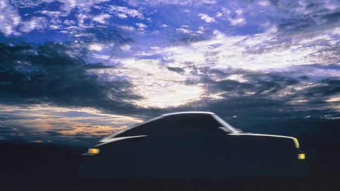 A Porsche 911 outlined against a sky filled with clouds