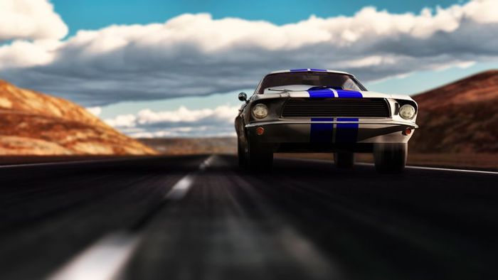 A 1966 Ford Mustang racing along a deserted desert highway.