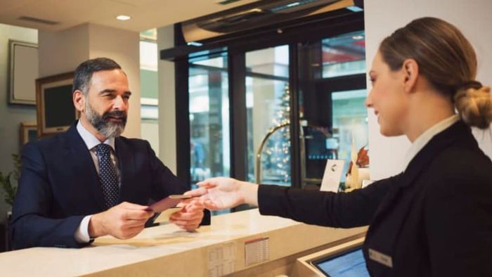 man settling payment at the hotel reception