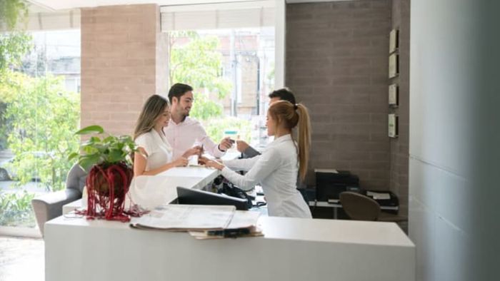 couple checking in at the hotel reception desk