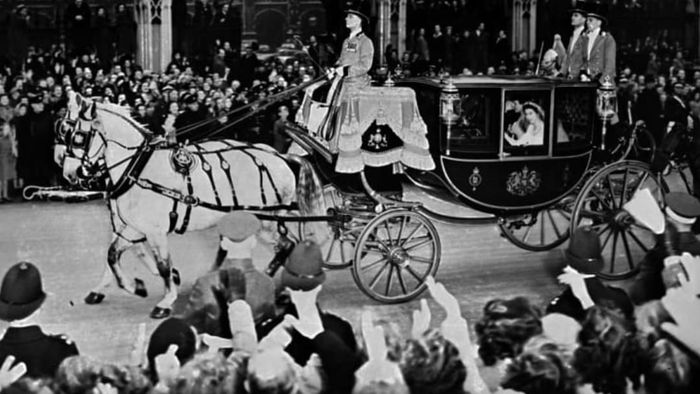 Queen Elizabeth II (in the coach) and her husband, Prince Philip, Duke of Edinburgh, were cheered by the crowd as they made their way to Buckingham Palace after their wedding ceremony on November 20, 1947.