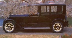 The 1920 Packard Twin Six Limo represents a refined, understated elegance, marked by a lack of brass trim and only minimal polished accents.