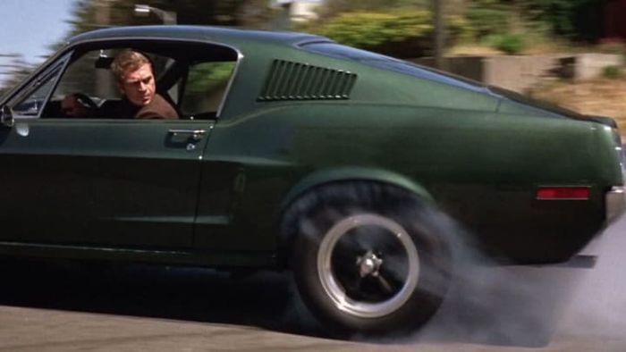 Steve McQueen takes the wheel of a 1968 Ford Mustang Fastback in the iconic movie Bullitt (1968).