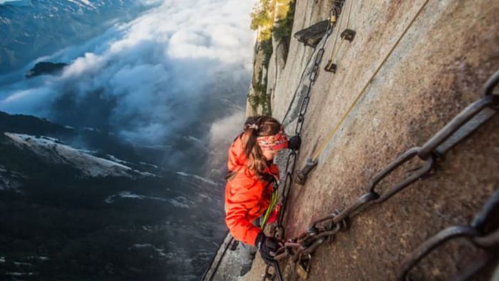 A woman navigating the steep paths of Mount Huashan
