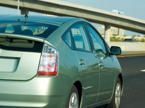 A hybrid vehicle travels along a California freeway.