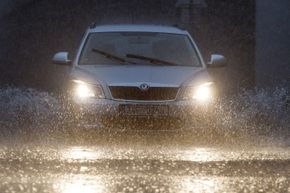 A vehicle navigates through flooded streets in Prague.