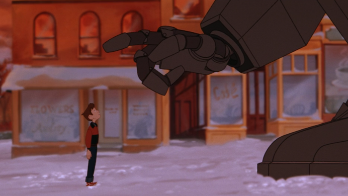 A still from The Iron Giant showing the Giant tenderly extending his hand toward Hogarth