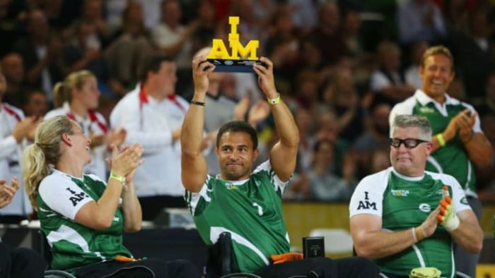 An athlete from the Invictus Games proudly displays a trophy