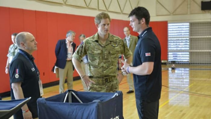 Prince Harry engages in conversation with a representative from the Warrior Games in the United States