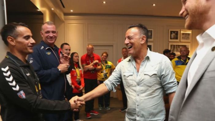 Bruce Springsteen greets a war veteran with a handshake at the Invictus Games