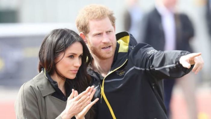 Prince Harry and Meghan Markle observe from the sidelines