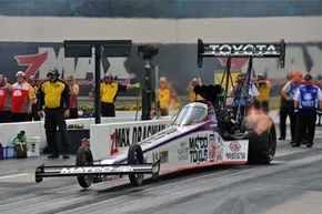Antron Brown accelerates the Matco Tools Top Fuel dragster at zMAX Dragway in Concord, North Carolina.