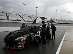 NASCAR crew members wait out a rain delay during a race.