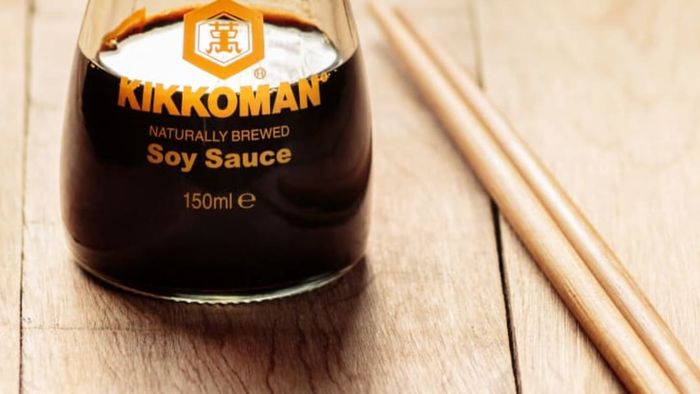 A glass bottle of Kikkoman soy sauce.