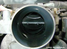 A car's throttle valve shown in a partially open position.