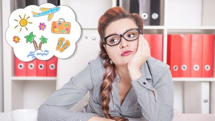 A woman looking bored, her thought bubble filled with images of palm trees, flip flops, suitcases, and an airplane.