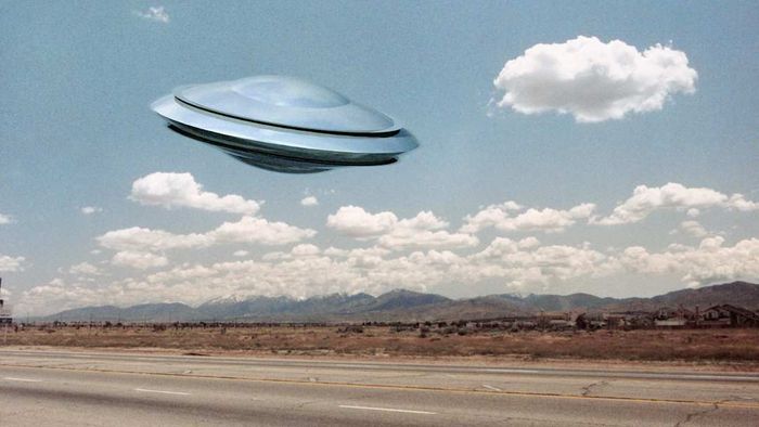 A UFO hovering above a road