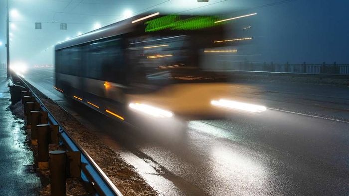 A blurry bus crossing a bridge