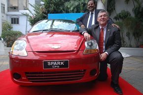 General Motors India President Karl Sylm (front) and Vice President of Corporate Affairs P. Balendran showcase the newly launched liquefied petroleum gas version of the compact Chevrolet Spark in Ahmadabad, India, on June 22, 2009.