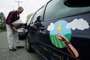 Lyle Rudensey fuels his car with homemade biodiesel, which he produced from used cooking oil in his garage, on April 22, 2009, in Seattle, Washington.