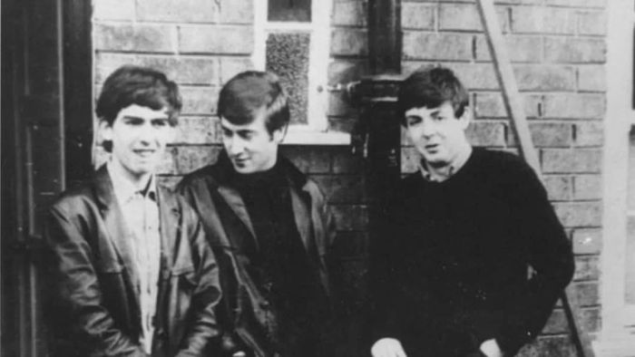 The Beatles posing outside Paul McCartney's Liverpool home around 1960.