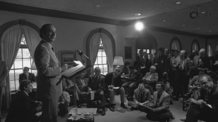 Press Secretary Ron Nessen conducting a daily press briefing at the White House around 1974.