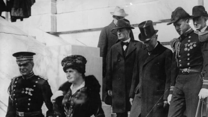 President Woodrow Wilson and his wife Edith accompanied by a Secret Service escort in 1917.
