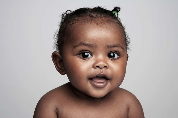 Baby girl (6-9 months) smiling, portrait