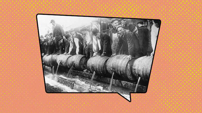 Authorities disposing of beer barrels during the Prohibition period.