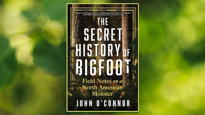 The cover of *The Secret History of Bigfoot* set against a blurred green backdrop