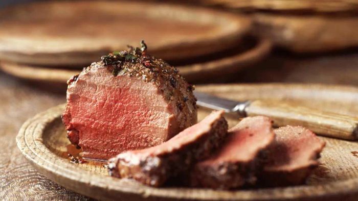 fillet of beef on wooden plate