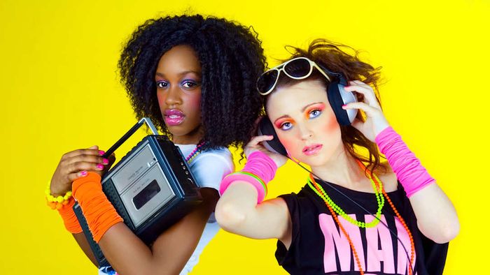 Women are seen sporting 1980s fashion styles in this image.