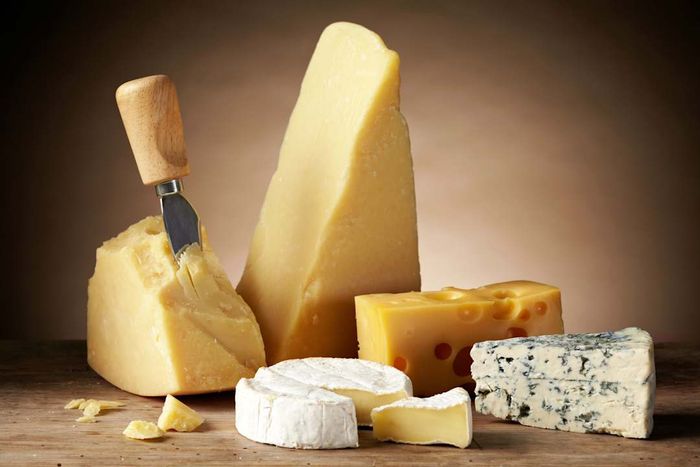 Assorted cheeses displayed on a cutting board