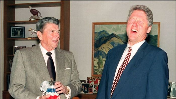 President Ronald Reagan gifts president-elect Bill Clinton a jar of red, white, and blue jelly beans.