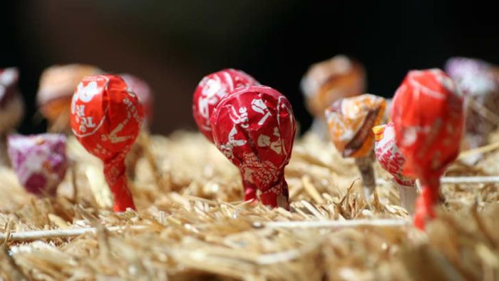 Tootsie Pops nestled in a bale of hay.