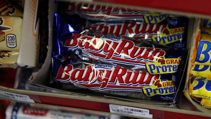 A pile of Baby Ruth bars neatly arranged in a box.