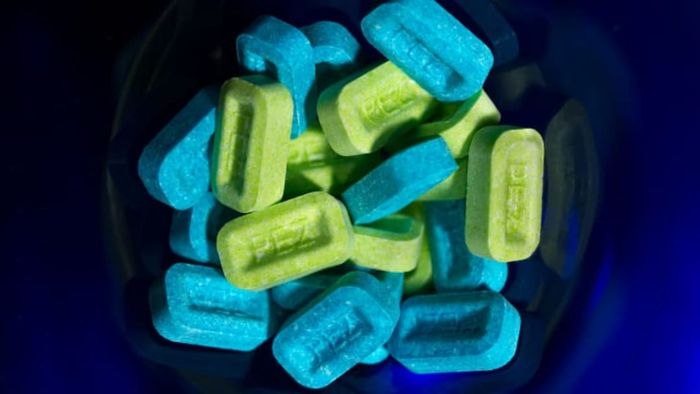 A collection of green and blue Pez candies.