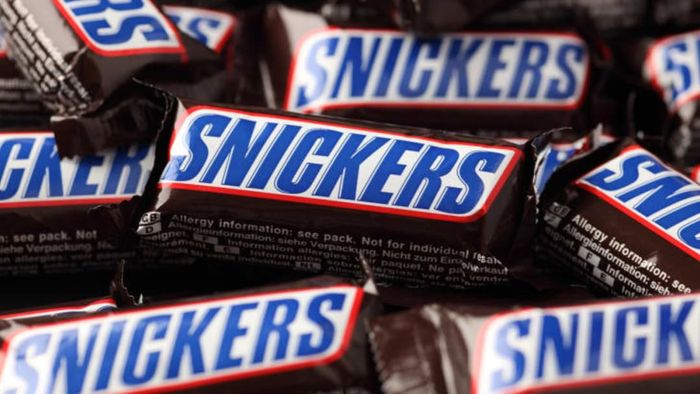 A stack of Snickers bars arranged together.