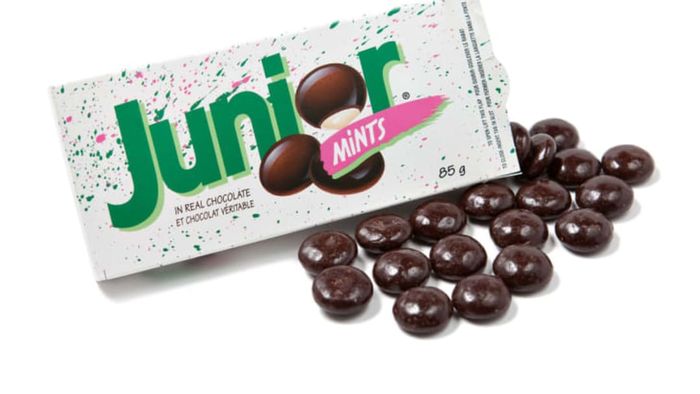 A box of Junior Mints candies opened and displayed on a plain white surface.