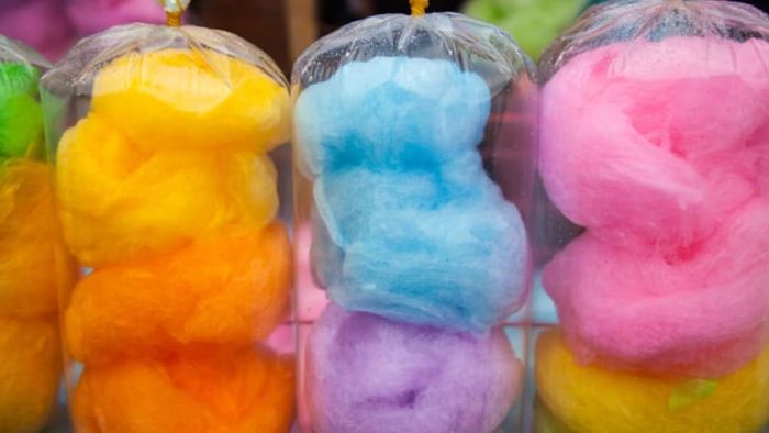 Bags of vibrant cotton candy in assorted colors.