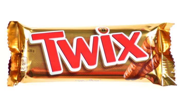 A Twix bar placed on a plain white surface.